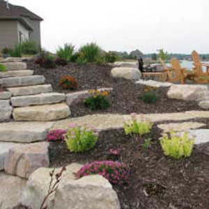Stone Walkway with a backyard and some shrubbery