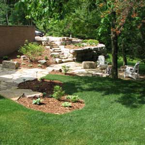 Stone Walkway with a backyard and some shrubbery